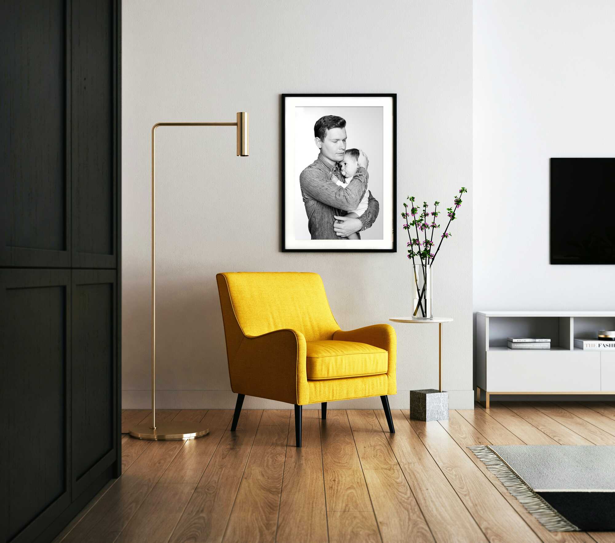 Modern living room with a yellow armchair, black and white framed picture, and a gold floor lamp.